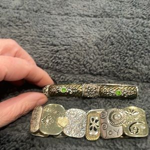 Two beautiful silver colored bracelets.